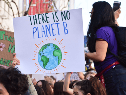 Person holding a climate protest sign