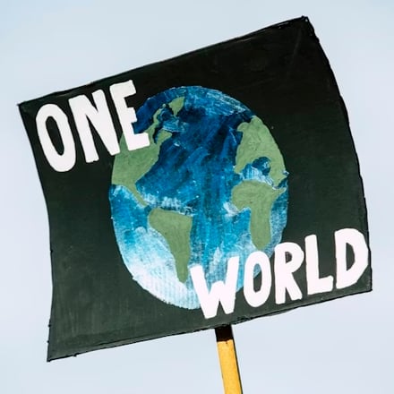 Sign reading "one world"